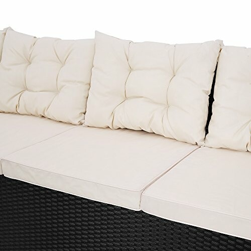 Outdoor sofa with white cushions.